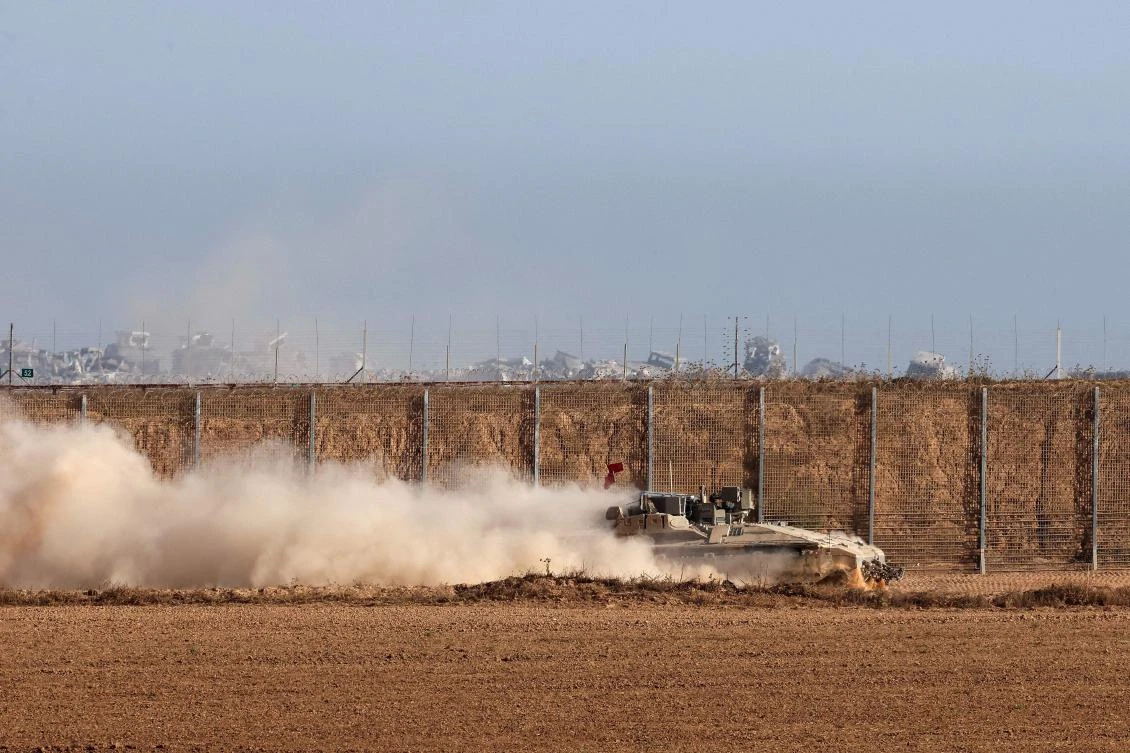 This picture taken from a position at Israel's border with the Gaza Strip shows Israeli troops deployed in the bordering area of the besieged Palestinian territory on July 17, 2025. (AFP)