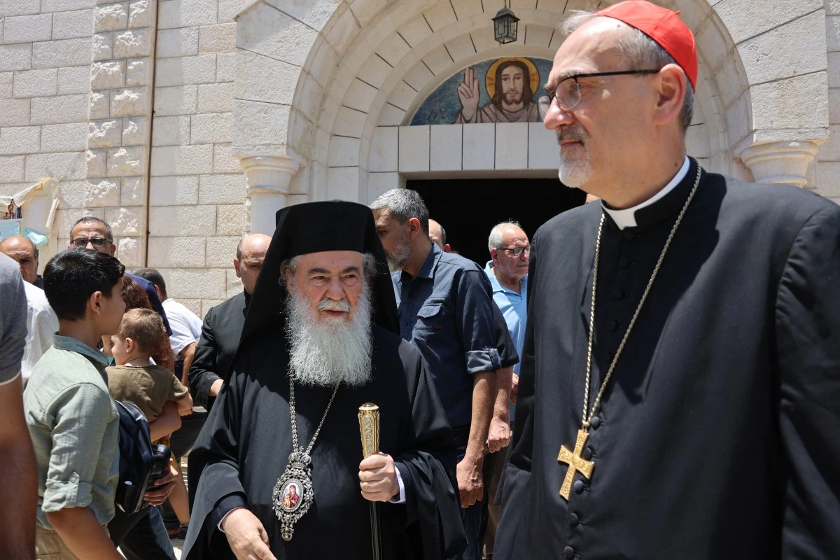 Latin Patriarch of Jerusalem Pierbattista Pizzaballa (R), Greek Orthodox Patriarch of Jerusalem Theophilos III (C) visit the Holy Family Church, a day after it was hit in an Israeli strike, in Gaza City. (AFP)