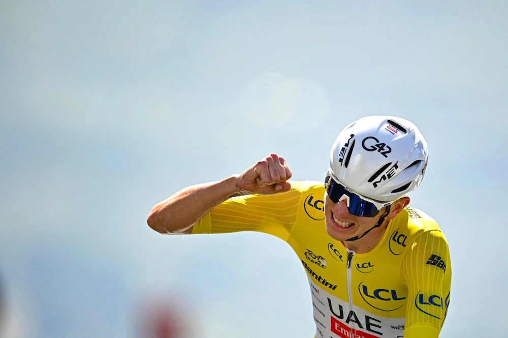 Tadej Pogacar powered to victory in an uphill time trial on stage 13 of the Tour de France on Friday to stretch his lead in the race to more than four minutes. (AFP)