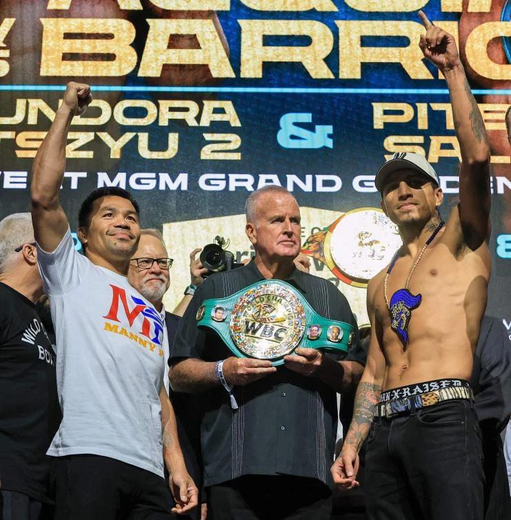TGB Promotions President Tom Brown, center, looks on as Manny Pacquiao, left, and WBC welterweight champion Mario Barrios pose during a ceremonial weigh-in at MGM Grand Garden Arena on July 18, 2025 in Las Vegas, Nevada. (Getty Images via AFP)