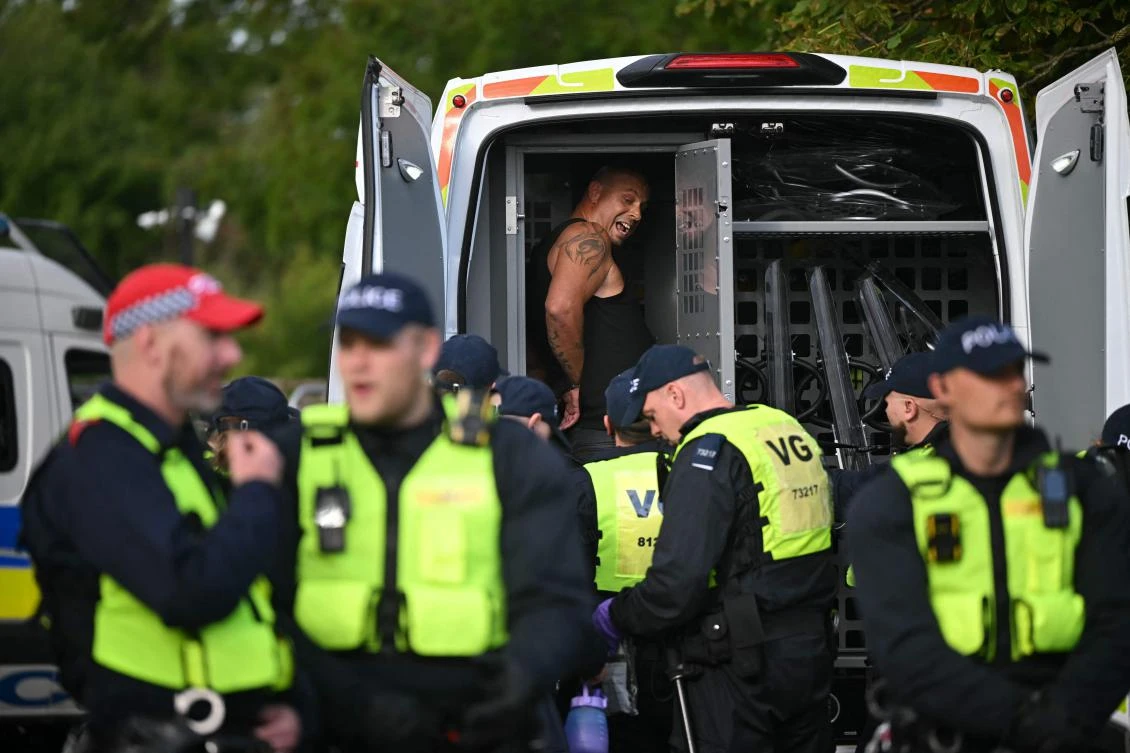 A man is arrested by police at a protest outside The Bell Hotel, which is housing asylum seekers, in Epping, northeast of London on July 20, 2025. (AFP)