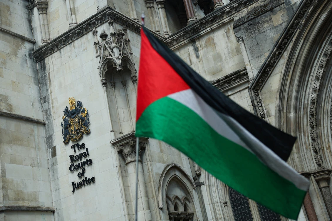 A person holds a Palestinian flag outside the High Court on the day of a hearing about the banned pro-Palestinian campaign organisation Palestine Action, in London, Britain, July 21, 2025. (Reuters)