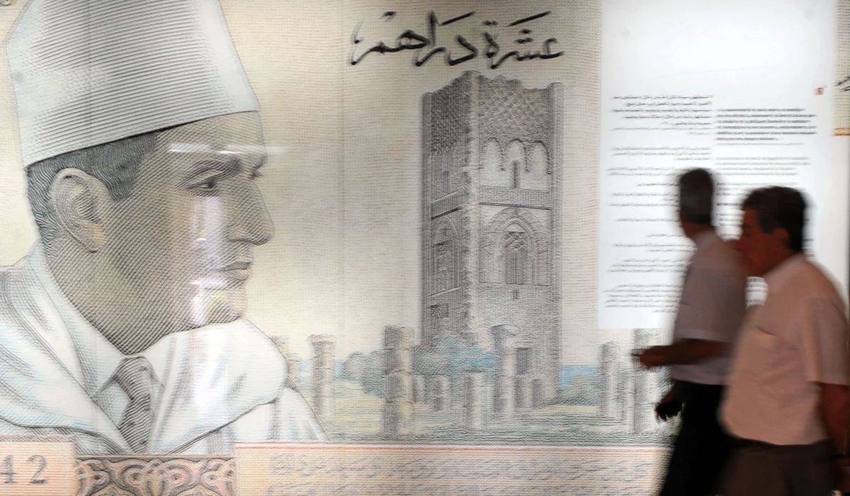 Visitors walk past a giant replica of a 10-dirham banknote dating back to the 1960s at the Numismatic Museum in the Moroccan capital Rabat on June 26, 2012. (AFP)