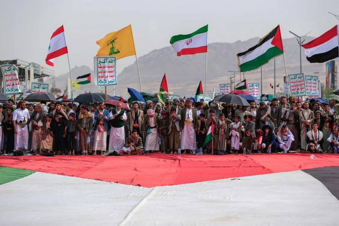 Yemenis gather around a large flag of Palestine during a rally in solidarity with Palestinians in the Houthi-run capital Sanaa on July 18, 2025. (AFP)