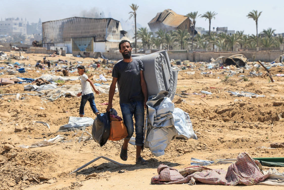 A displaced Palestinian walks in the aftermath of an Israeli military operation in Deir Al-Balah, in the central Gaza Strip, July 22, 2025. (Reuters)