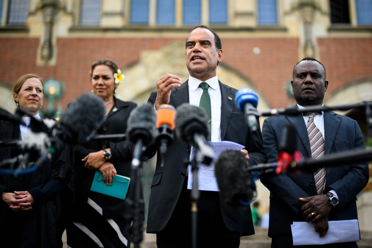 Vanuatu's Climate Change Minister Ralph Regenvanu (3rd L) speaks to the media in The Hague on July 23, 2025, after an ICJ session tasked with issuing the first Advisory Opinion on states' legal obligations to address climate change. (AFP)