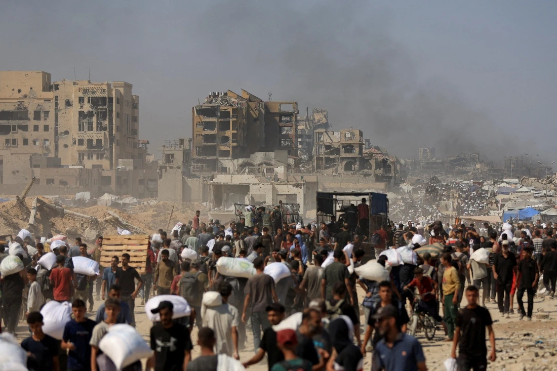 Palestinians gather for aid supplies in Beit Lahia, Gaza Strip. (Reuters)