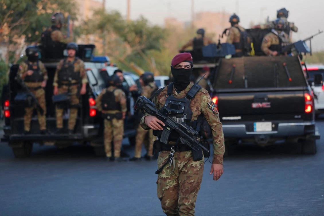 Iraqi police clash with paramilitary fighters who stormed government building