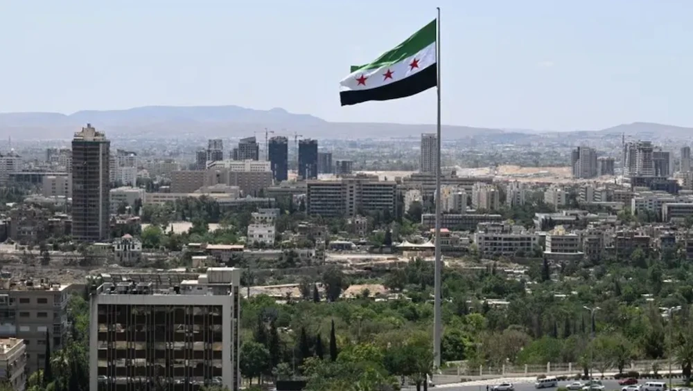 A large Syrian flag flutters above Tishreen Park in Damascus on June 4, 2025. (AFP)