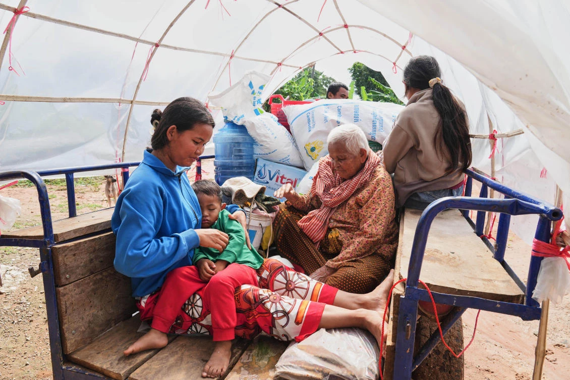 A Cambodian family sits on a tractor cart of as they return home from a temporary shelter in Prasat Roboeuk village of Oddar Meanchey province on July 29, 2025. (AP)