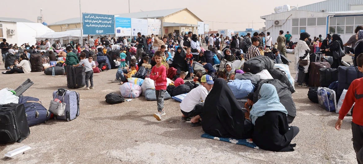 Afghan families deported from Iran gather at a border crossing in Herat province, Afghanistan. (Photo courtesy of UNHCR)