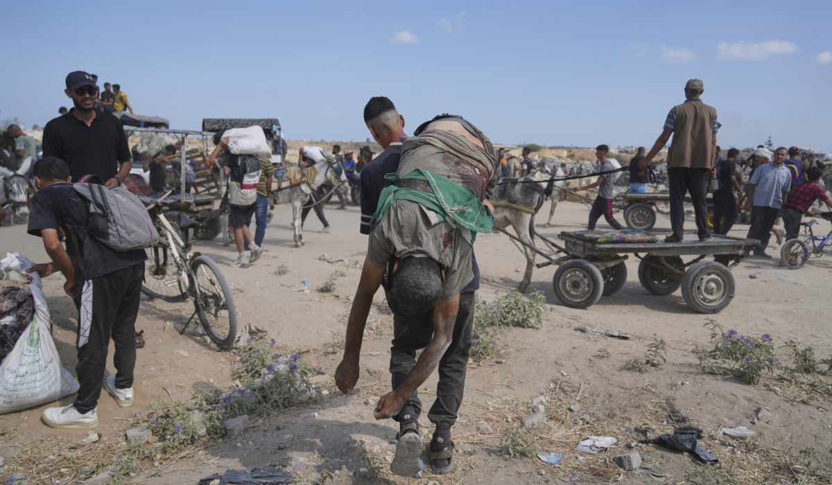 A Palestinian carries the body of a man killed while trying to receive aid center in Gaza, Aug. 4, 2025. (AP)
