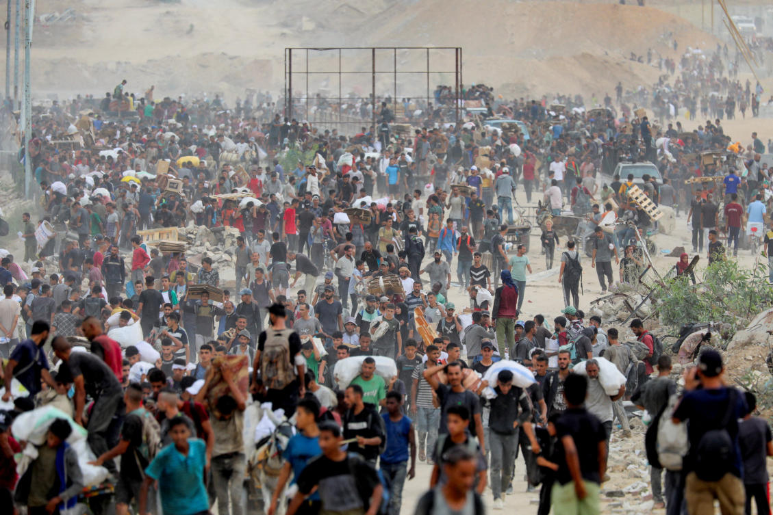 Above, Palestinians carry aid supplies which they received from the US-backed Gaza Humanitarian Foundation in the central Gaza Strip on Aug. 1, 2025. Gaza’s civil defense agency said two people were killed while waiting near an aid distribution site. (Reuters)
