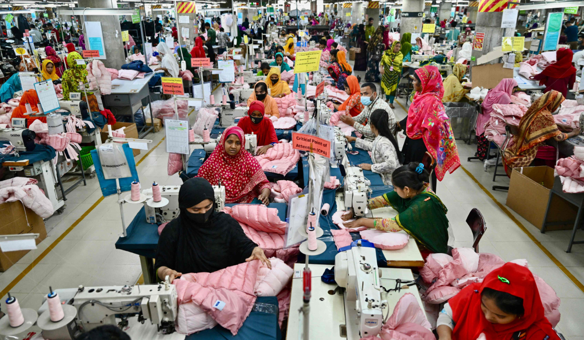 Workers are engaged at their sewing stations in a garment factory in Savar, on the outskirts of Dhaka, on April 9, 2025. (AFP)