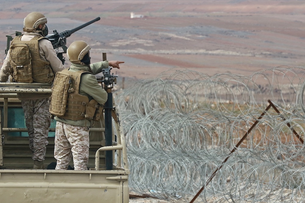 Above, Jordanian army soldiers patrol along the border with Syria to prevent trafficking. (AFP file photo)