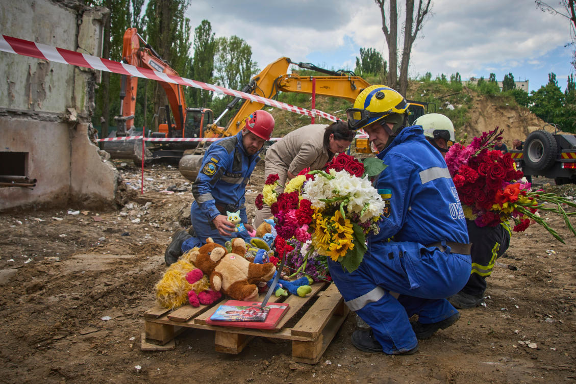 Rescuers lay toys and flowers on the site of Russia’s Thursday night missile strike that hit a multistory residential house killing 31 civilians including five children in Kyiv, Ukraine, Friday, Aug. 1, 2025. (AP)