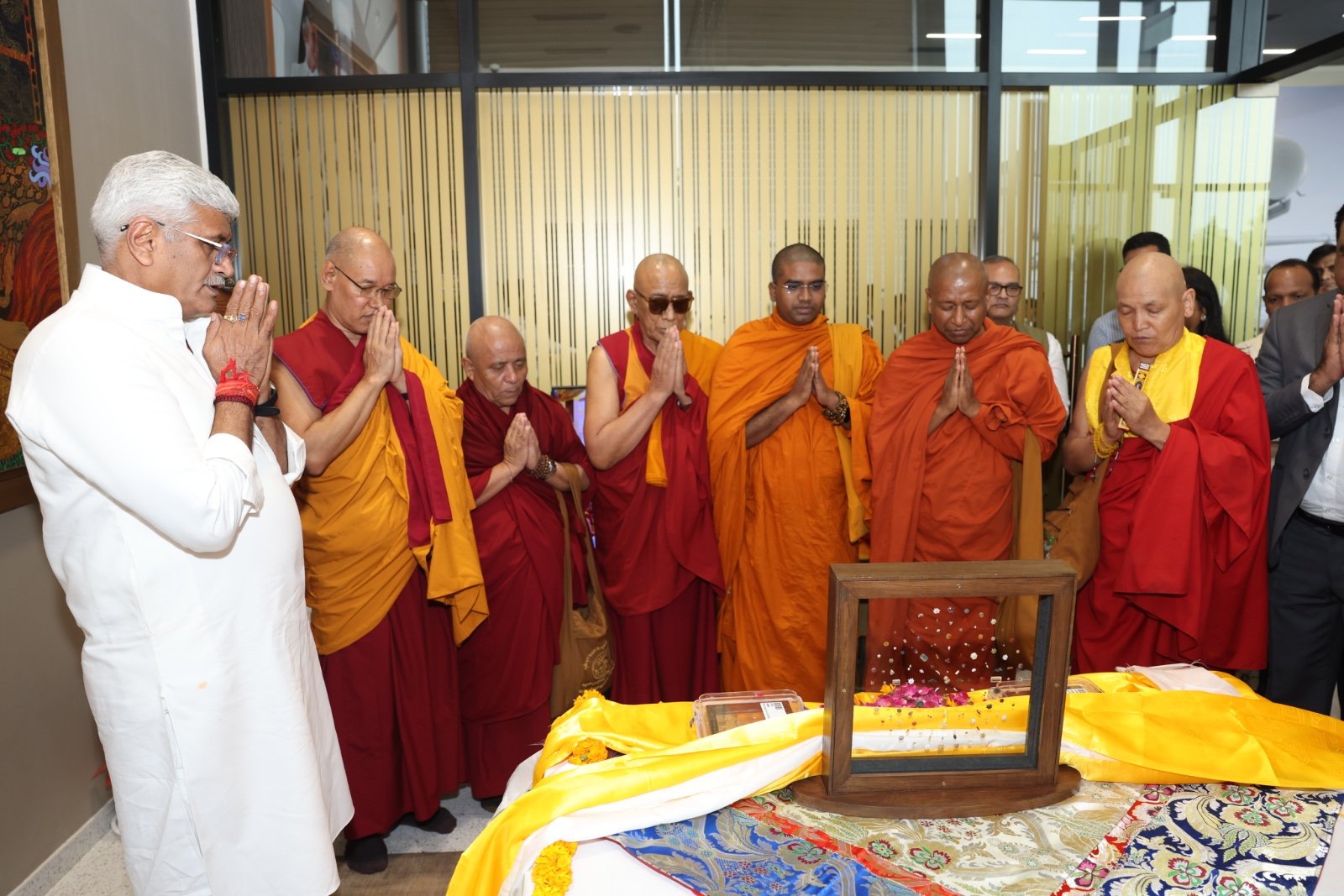 India's Minister of Culture and Tourism Gajendra Singh prays with monks after receiving repatriated sacred Piprahwa Gems of the Historical Buddha, at the airport in New Delhi, India on July 30. (India's Press Information Bureau)