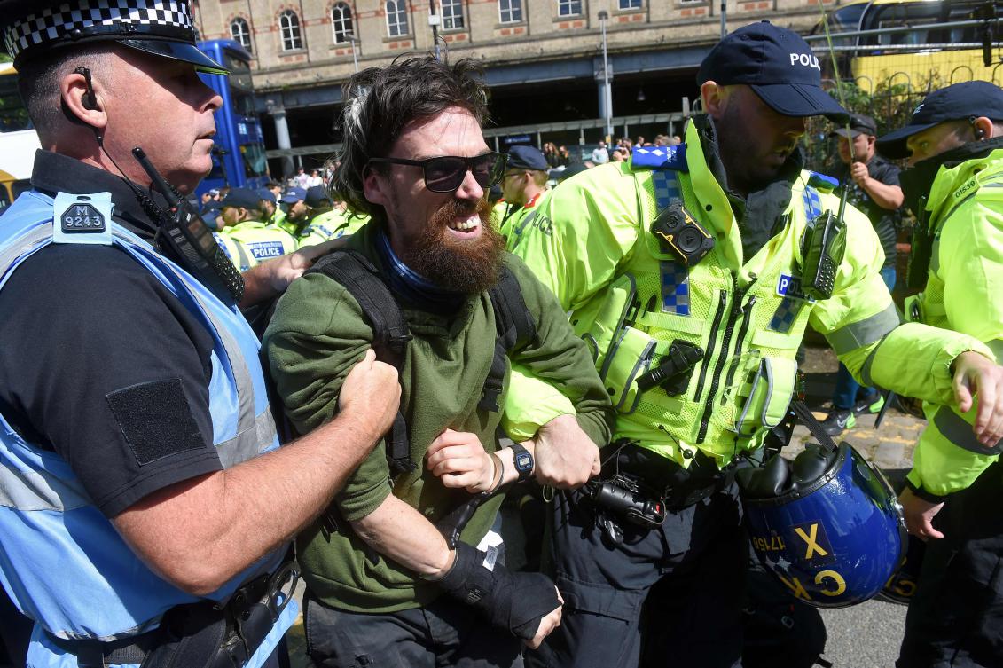 An opposition protester is arrested during protests against a Britain First ‘March for Remigration’ demonstration, in Manchester, on Aug. 2, 2025. (AFP)