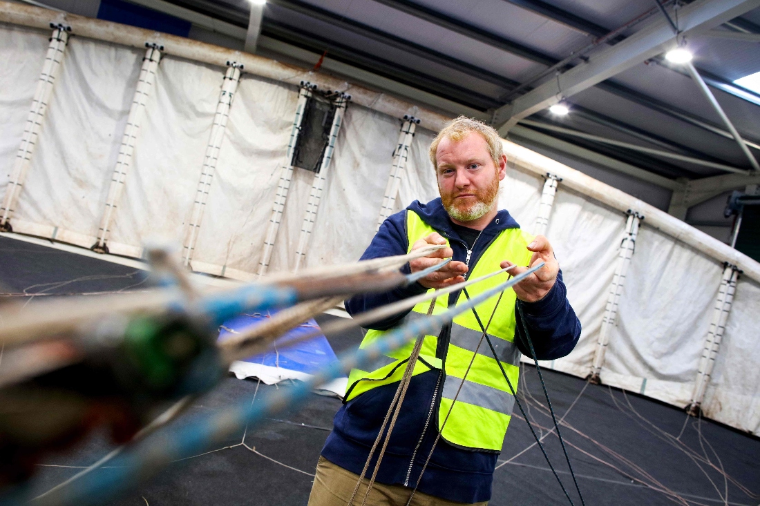 Chief Pilot Padraic Doherty works with one of the Kitepower Kites in a hanger at their launch site at Bangor Erris, Ireland. (AFP)