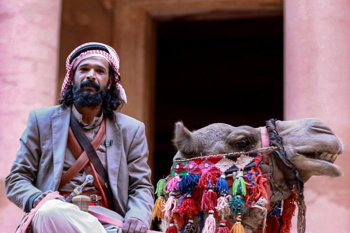 A camel guide rides his camel outside the Treasury in the ruins of the ancient Nabatean city of Petra in southern Jordan. (File/AFP)