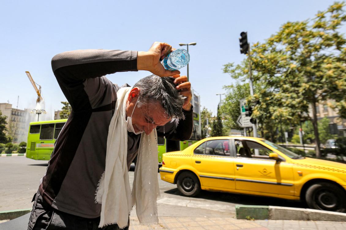A man pours water on his head from a bottle to cool off during a heat wave in Tehran on July 11, 2023.(File/AFP)