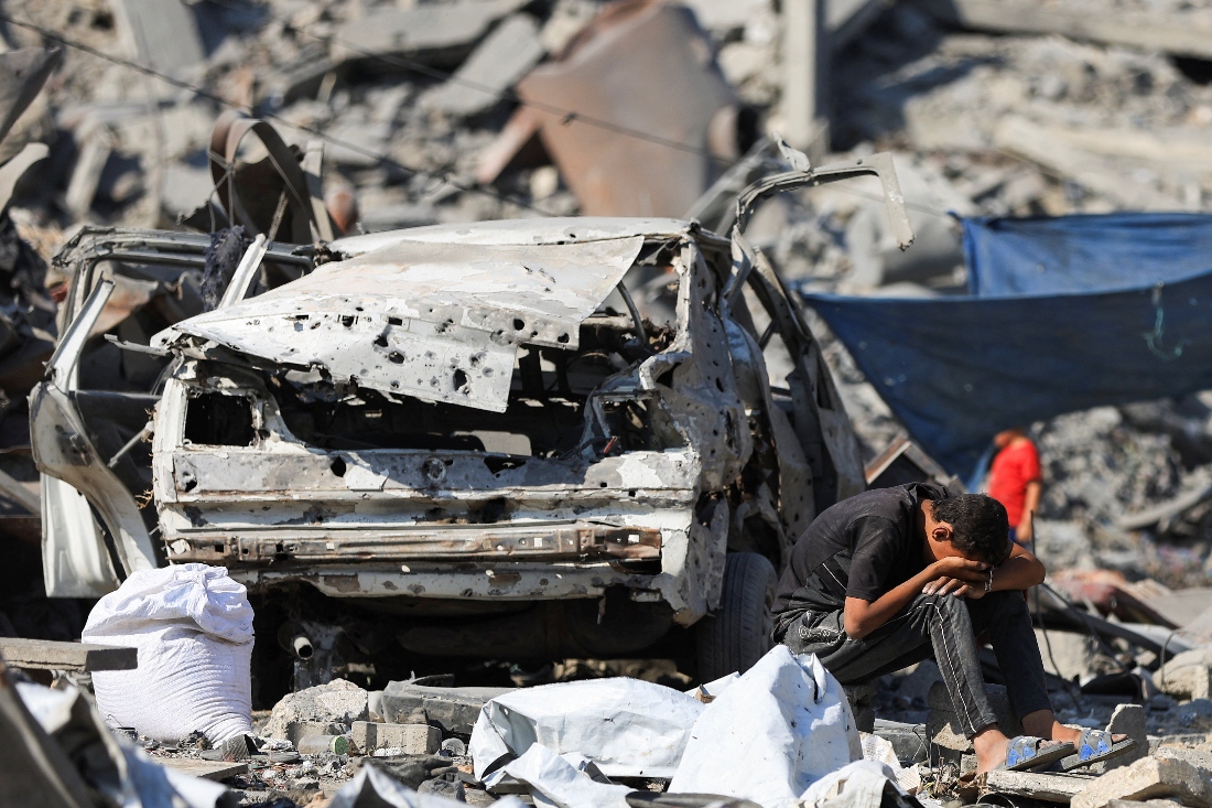 A Palestinian boy reacts at the site surrounding an evacuated UNRWA clinic where displaced people were taking shelter, following an overnight Israeli strike, in Gaza City. (Reuters)