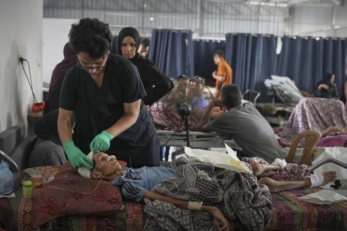 Dr. Jamal Salha tends to a young patient at Shifa Hospital in Gaza City, July 7, 2025. (AP)