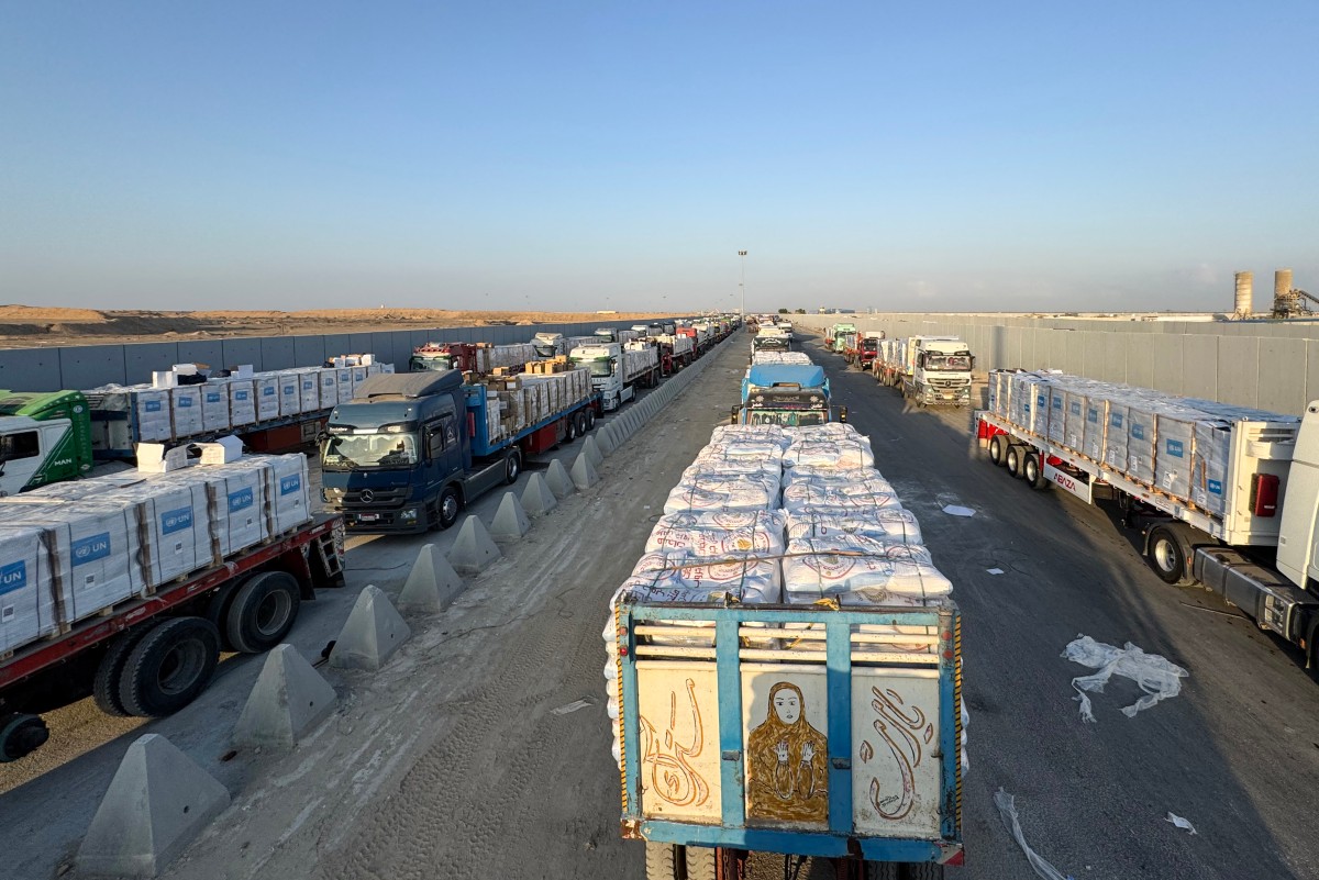 Trucks loaded with humanitarian aid await permission on the Egyptian side of the Rafah crossing with the Gaza Strip, to drive toward the besieged Palestinians territory on August 3, 2025. (File/AFP)