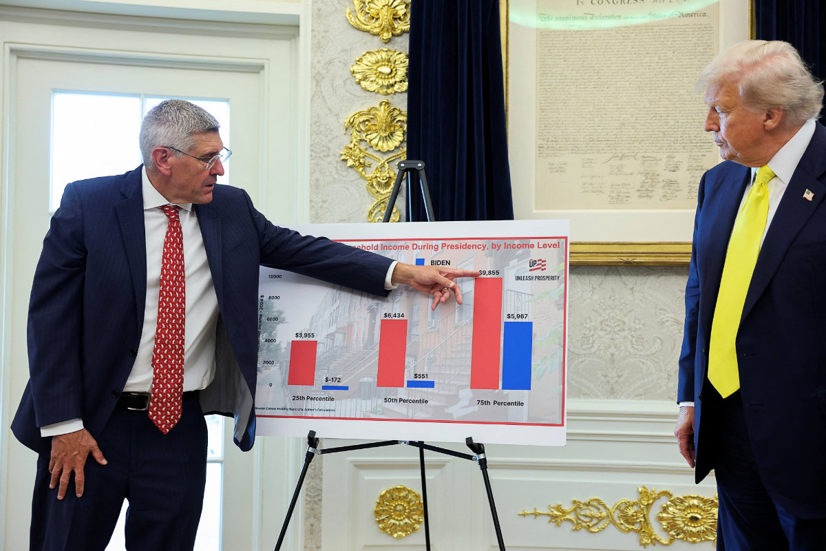Steve Moore points to a board showing Census Monthly Basic CPS to support his claims that the US economy was solid under President Donald Trump. (Reuters)