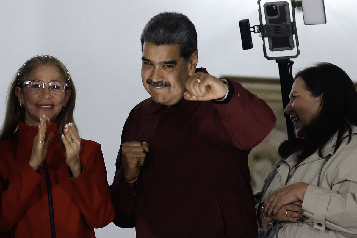 Venezuelan president Nicolas Maduro (C), First Lady Cilia Flores (L), and Caracas mayor Carmen Melendez gesture to the crowd after results were released following municipal elections in Caracas, Venezuela, in the early morning of July 28, 2025. (AFP)
