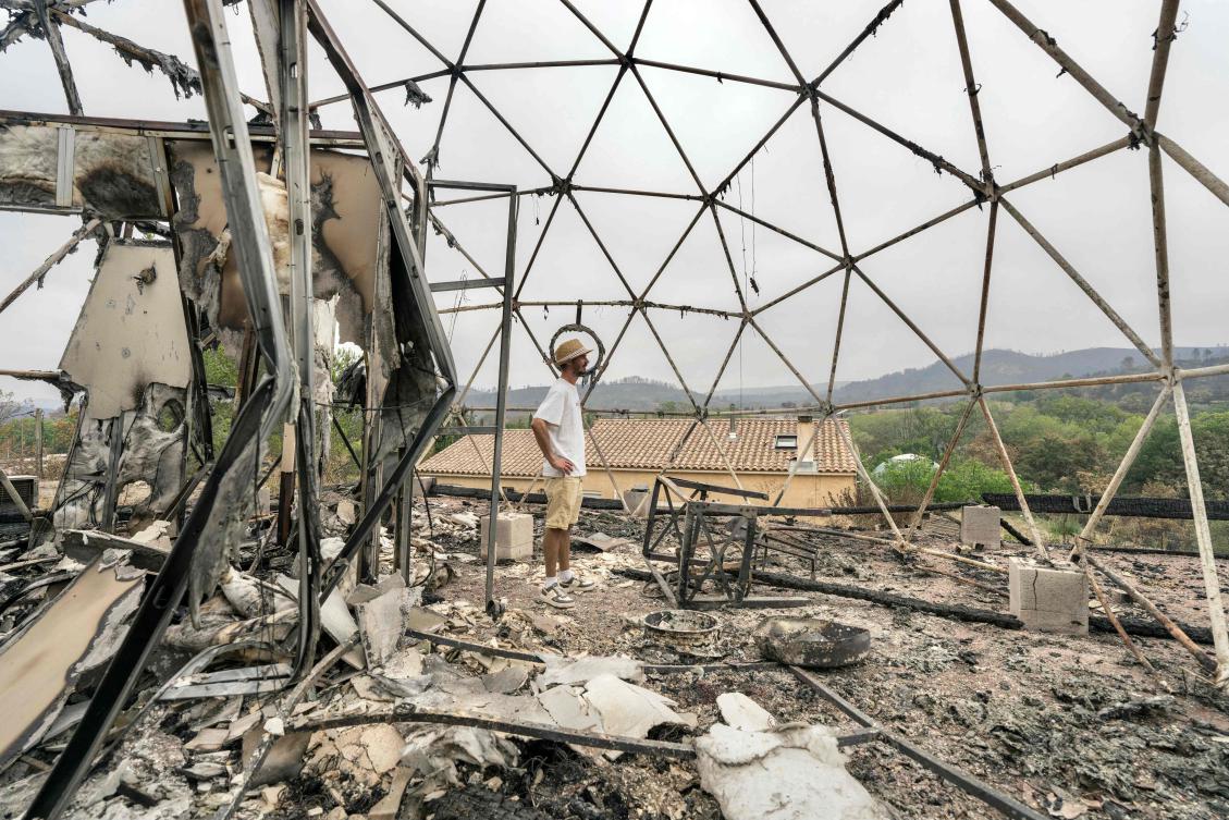 The owner of a tourist bubble home stands amid the damage caused following wildfires in Durban-Corbieres, in the Aude department, southern France on Aug. 9, 2025. (AFP)