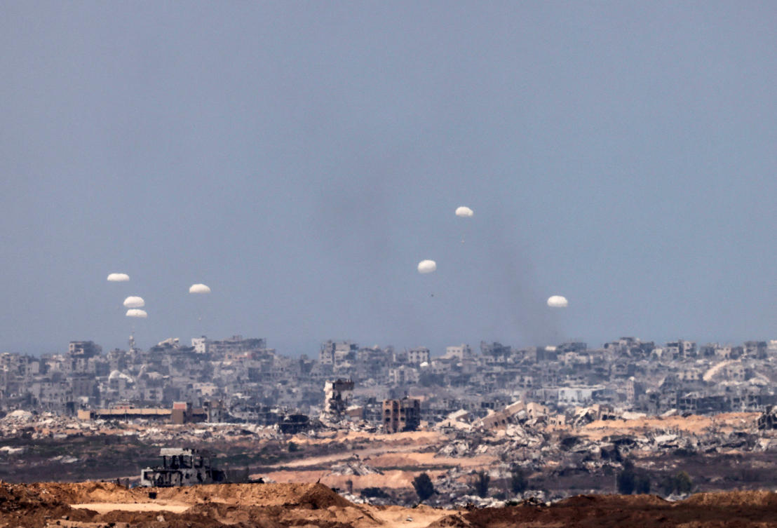 Humanitarian aid packages are airdropped over the Gaza Strip, as seen from Israel on Saturday. (Reuters)