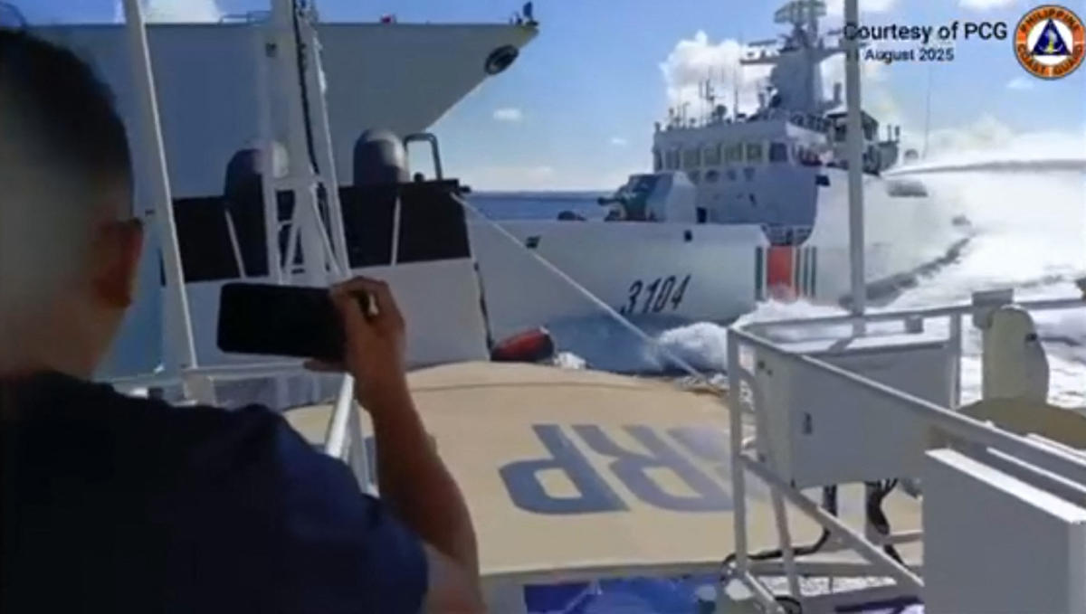 A handout video grab released and taken on Aug. 11, 2025 shows an incident between a Chinese Navy vessel, left, and a Chinese Coast Guard ship, right, as seen from a Philippine fisheries boat near Scarborough Shoal in the disputed South China Sea. (Philippine Coast Guard/AFP)