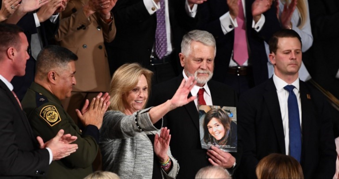 Carl and Marsha Mueller hold up a picture of their daughter Kayla, as they attend the State of the Union address at the US Capitol in Washington, US. (AFP)