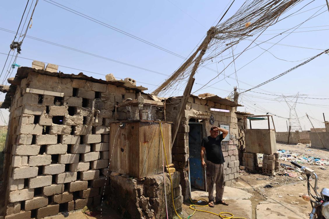 An Iraqi electrician takes a break from working on a power generator in the southern city of Diwaniyah on August 10, 2025, amidst rising temperatures, chronic water shortages and power cuts. (AFP)