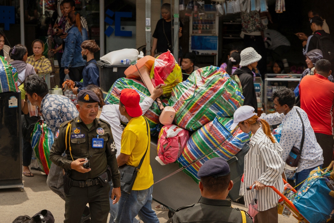 Military policemen patrol the main road of Kamrieng as migrant workers re-enter Cambodia through the Daung International Border Check Point between Cambodia and Thailand. (AP)