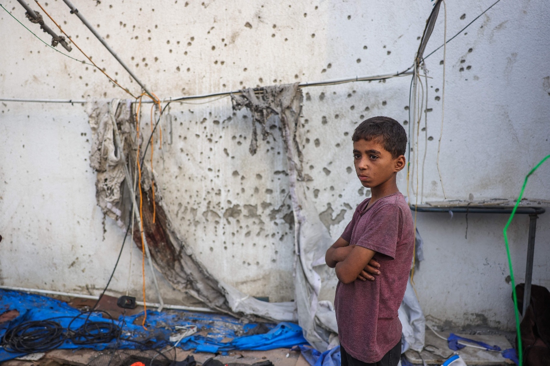 A Palestinian boy stands beside the destroyed Al Jazeera tent at Al-Shifa Hospital in Gaza City. (AFP)