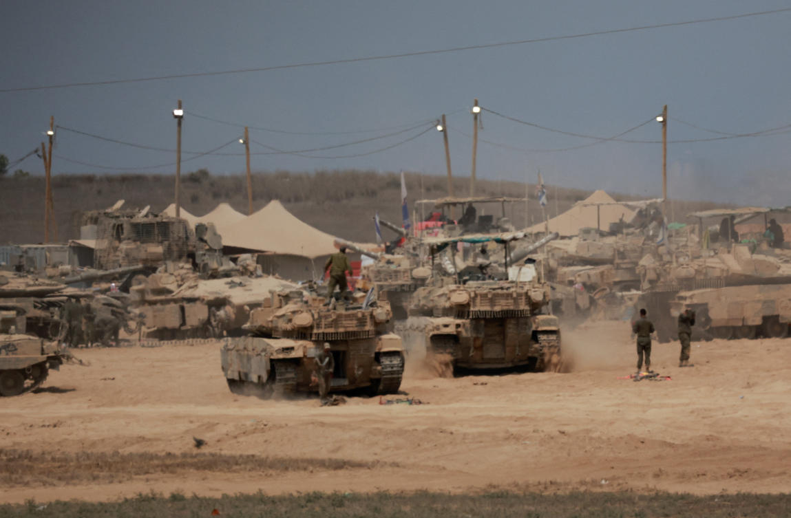 Above, military vehicles on the Israeli side of the border with Gaza on Aug. 12, 2025. (Reuters)