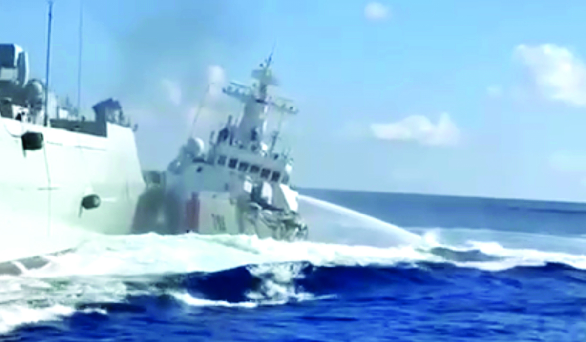 A damaged Chinese coast guard ship, right, is seen beside a Chinese navy vessel, after they collided while chasing a Philippine fisheries boat on Monday. (AP)
