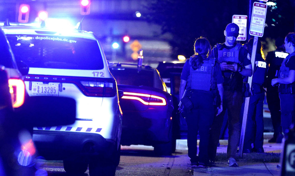Federal and local law enforcement officers investigate a suspect’s vehicle on South Capitol Street on August 11, 2025 in Washington, DC. President Donald Trump announced a federal takeover of DC police and mobilization of the National Guard, saying the moves are necessary to restore order in the city. (AFP)