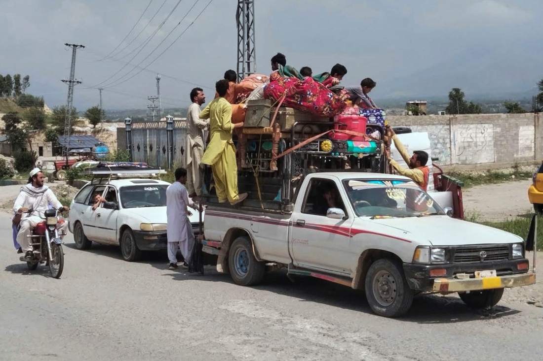 Volunteers offer water to Internally Displaced People, who flee from their homes due to security forces launched a targeted operation against militants, at a highway near Khar, the main town of Bajaur, a northwestern Pakistani district bordering Afghanistan. (AP)