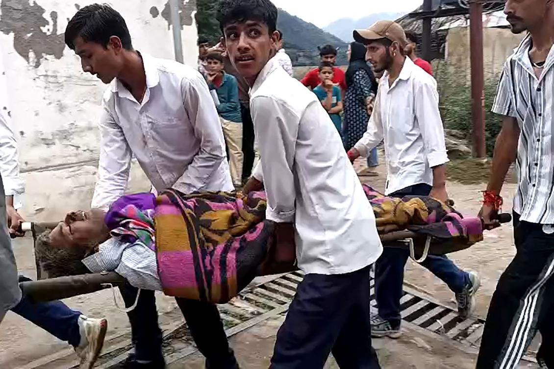 An injured person is carried on a stretcher to a hospital in Paddar area, Kishtwar district on Thursday. Powerful torrents driven by intense rain smashed into a Himalayan mountain village in Indian-administered Kashmir. (AFP)
