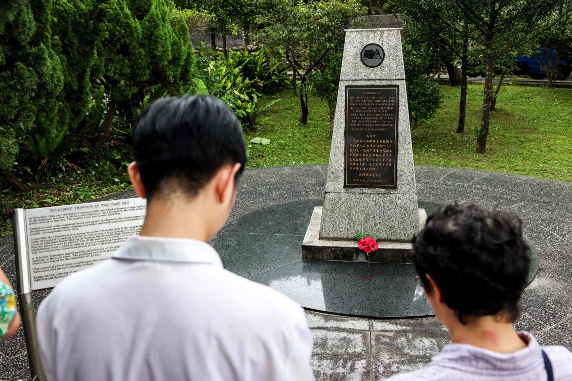 Residents pay tribute to a monument to people who passed away during WWII at Taiwan Prisoners of War Memorial and Peace Park in New Taipei City on July 31, 2025. (AFP)