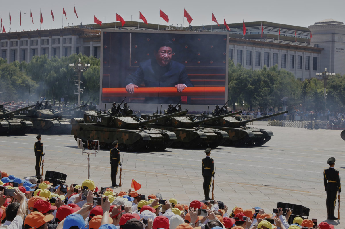 Chinese President Xi Jinping is displayed on a screen as Type 99A2 Chinese battle tanks take part in a parade in Beijing. (AP file photo)