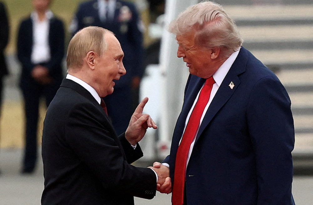 US President Donald Trump shakes hand with Russian President Vladimir Putin, as they meet to negotiate for an end to the war in Ukraine. (Reuters)