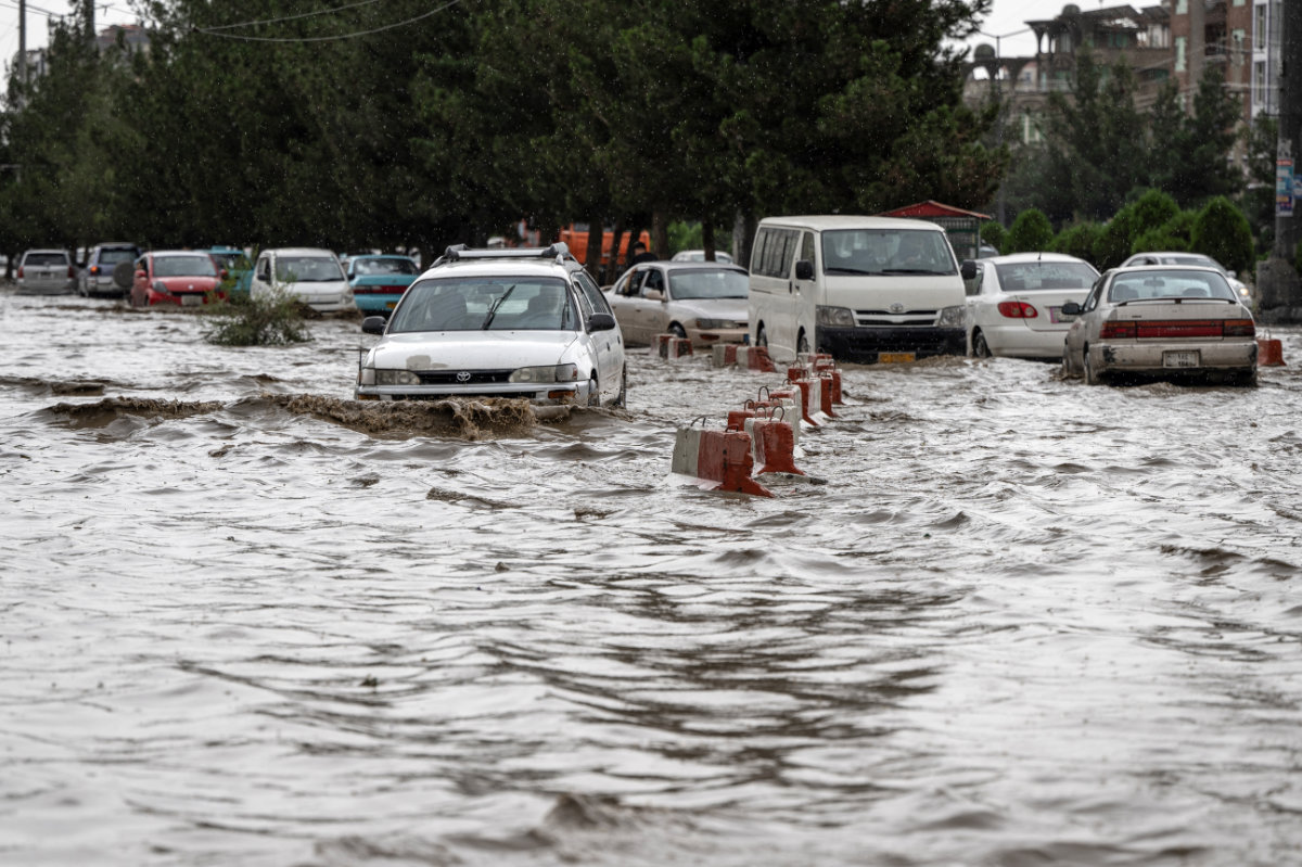 Vehicles move through a flooded road after heavy rainfall in Kabul on July 13, 2025. (AFP)