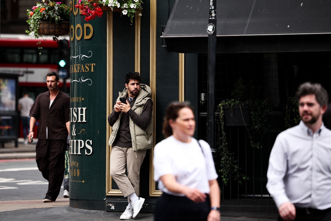 Diego Galdino, who hunts and films pickpockets in London and posts the footage on social media, watches for pickpockets in London, UK. (AFP)