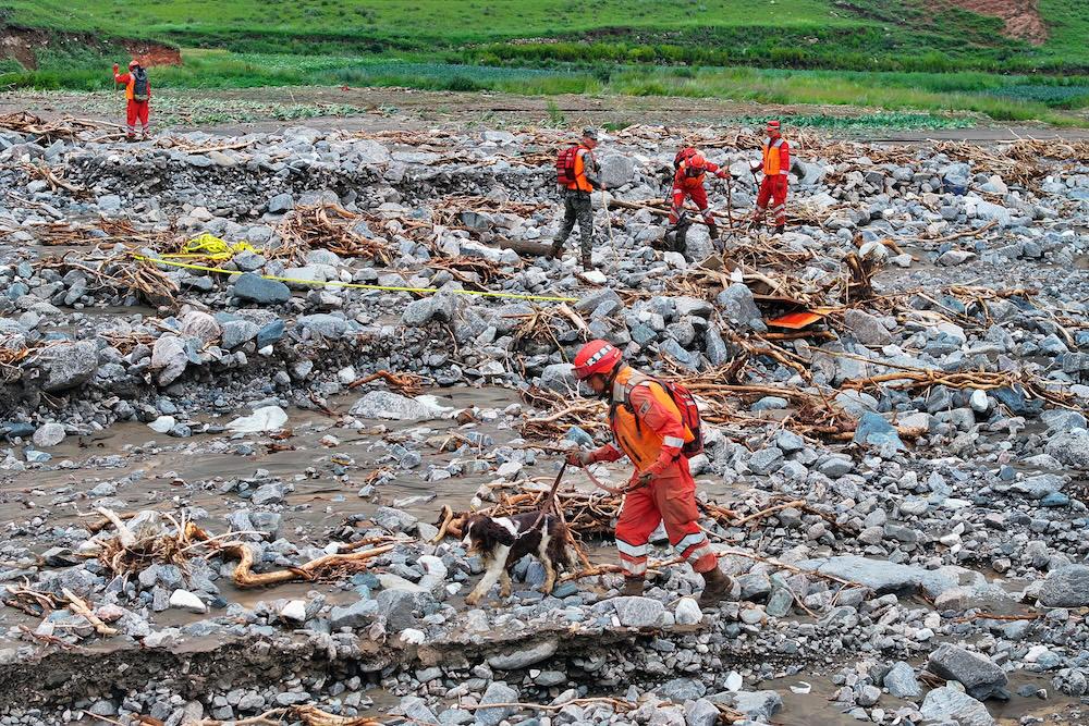 China has suffered weeks of extreme weather since July, battered by heavier-than-usual downpours with the monsoon stalling over its north and south. Above, rescue workers search for victims a day after a flash flood in Yuzhong county. (AFP)