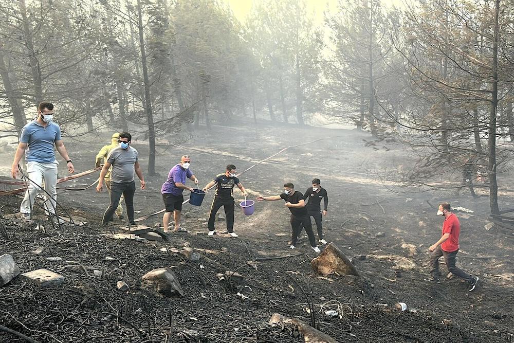 Residents work to extinguish wildfire in Canakkale, northwestern Turkey in the Marmara region on Aug. 8, 2025. (Demiroren News Agency/AFP)