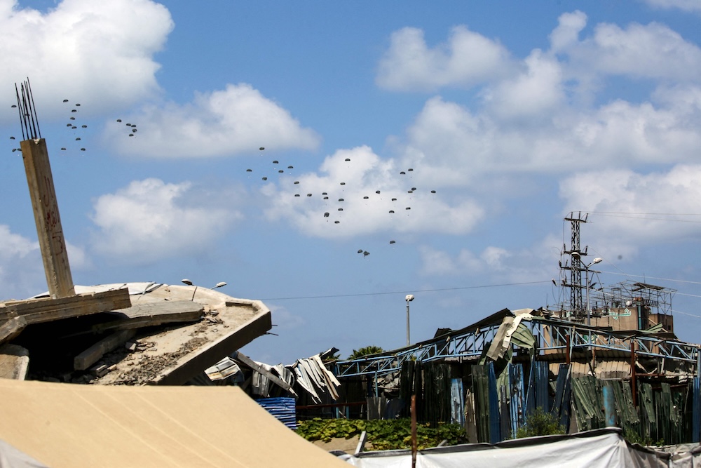 Above, humanitarian aid being airdropped over the besieged Gaza Strip on Aug. 17, 2025. (AFP)